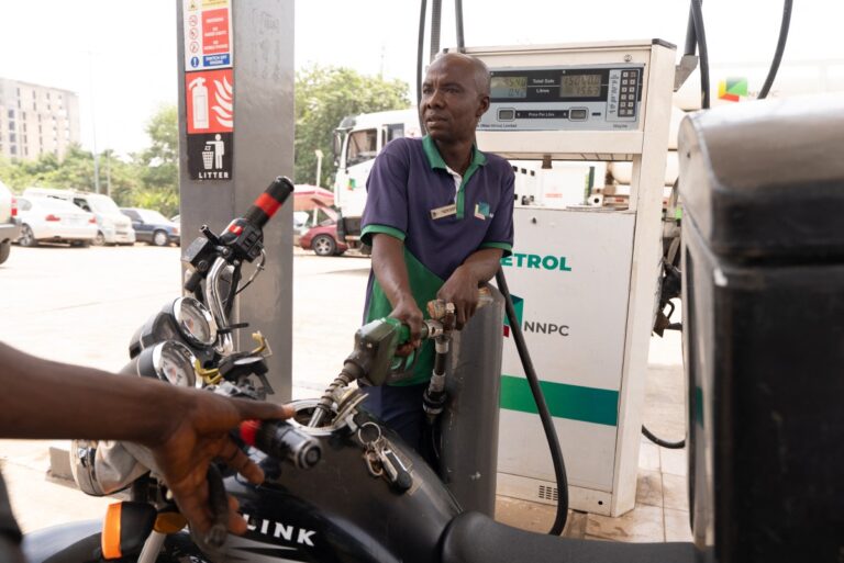 A fuel attendant pumps petrol into a motorcycle at a fuel station in Abuja on March 9, 2026, after transport fares increased following a recent hike in petrol prices. Africa is feeling the impact of rising oil prices and threats to shipping, as the continent again suffers from events largely beyond its control. Pump prices in Nigeria were up around 14 percent this week. (Photo by Light Oriye Tamunotonye / AFP)