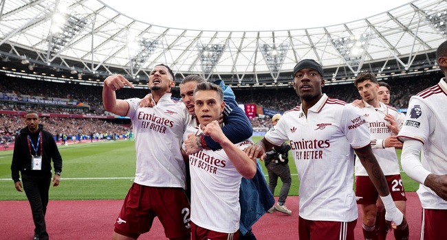 Arsenal’s Belgian midfielder #19 Leandro Trossard celebrates scoring the team’s first goal during the English Premier League football match between West Ham United and Arsenal at the London Stadium, in east London on May 10, 2026. (Photo by Adrian DENNIS / AFP)