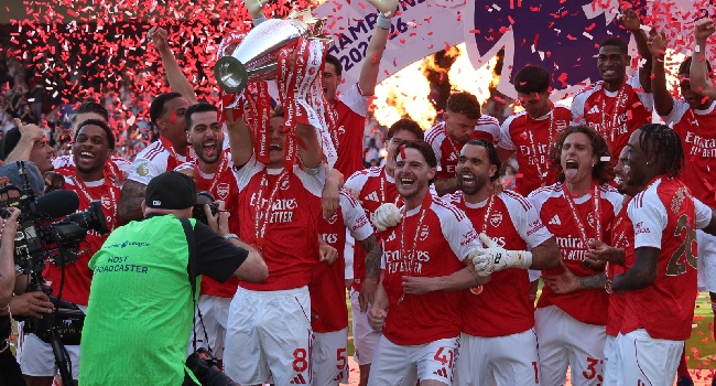 Arsenal’s Norwegian midfielder Martin Odegaard lifts the Premier League trophy at a presentation ceremony on the pitch after the English Premier League football match between Crystal Palace and Arsenal at Selhurst Park in south London on May 24, 2026. Photo by ADRIAN DENNIS / AFP