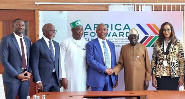 Photo shows President Tinubu (second from right) in a handshake with Motsepe (third from right), while Mrs Odumegwu-Ojukwu (right), Gusau (third from left), Pinnick (second from left) and Samson Adamu (left) watch.