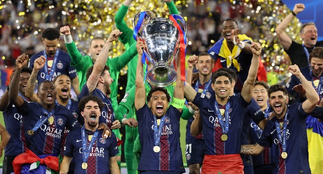 Paris Saint-Germain’s Brazilian defender #05 Marquinhos lifts the trophy after winning the UEFA Champions League final football match between Paris Saint-Germain (PSG) and Arsenal FC at the Puskas Arena in Budapest on May 30, 2026. (Photo by Odd ANDERSEN / AFP)