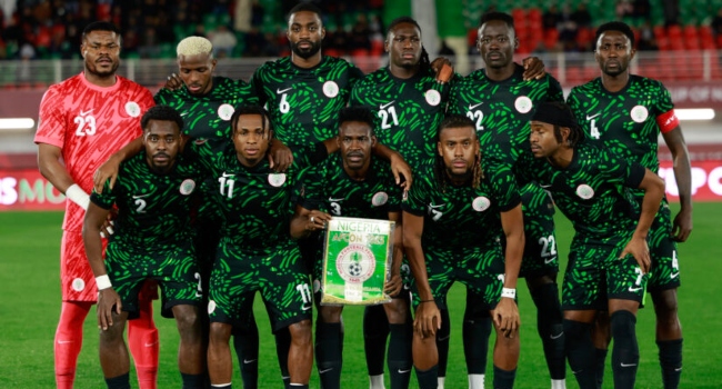 (From L) Nigeria’s goalkeeper Stanley Nwabali, Nigeria’s defender Bright Osayi-Samuel, Nigeria’s forward #09 Victor Osimhen, Nigeria’s forward #11 Samuel Chukwueze, Nigeria’s defender #06 Semi Ajayi, FC Porto’s Nigerian defender #12 Zaidu Sanusi, Nigeria’s defender #21 Calvin Bassey, Nigeria’s forward #17 Alex Iwobi, Nigeria’s forward #22 Akor Adams, and Nigeria’s midfielder #04 Wilfred Ndidi pose prior the Africa Cup of Nations (CAN) Group C football match between Nigeria and Tanzania at Fez Stadium in Fes on December 23, 2025. (Photo by Abdel Majid BZIOUAT / AFP)