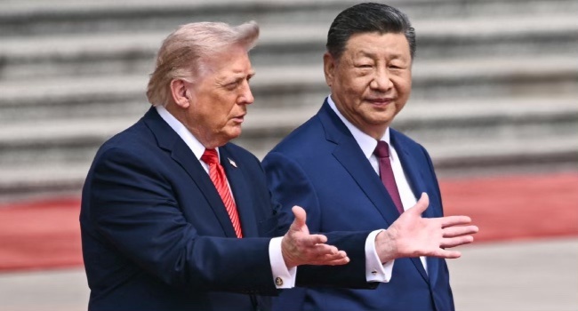 US President Donald Trump (L) takes part in a welcome ceremony with China’s President Xi Jinping at the Great Hall of the People in Beijing on May 14, 2026. (Photo by Brendan SMIALOWSKI / AFP)