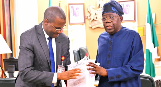 ICPC’s Chairman, Musa Aliyu (L) presents the interim report of a probe on the disputed Presidential Foreign Investment Promotion Council to President Bola Tinubu (R) at the State House in Abuja on Thursday August 6, 2026.