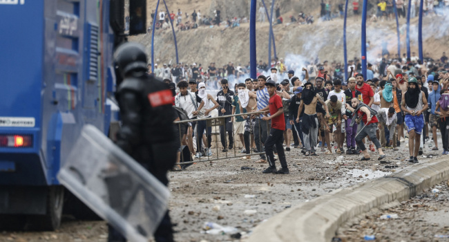 Moroccan security forces clash with migrants attempting to cross into Spain’s North African enclave of Ceuta near the town of Fnideq, on the Morocco-Spain border, on July 31, 2026.